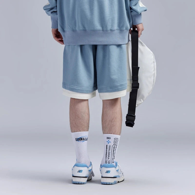 Close-up of light blue fake two-piece shorts highlighting contrasting stitching.