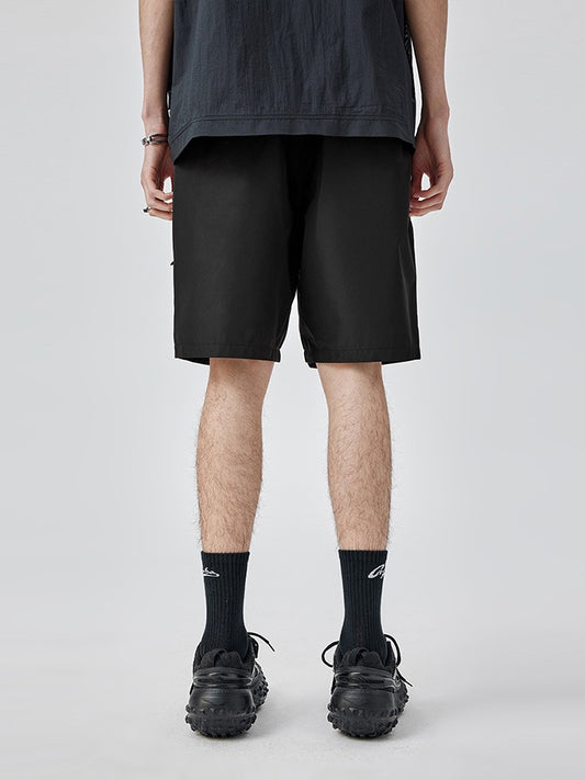 Men's black cargo shorts made from durable ripstop fabric.