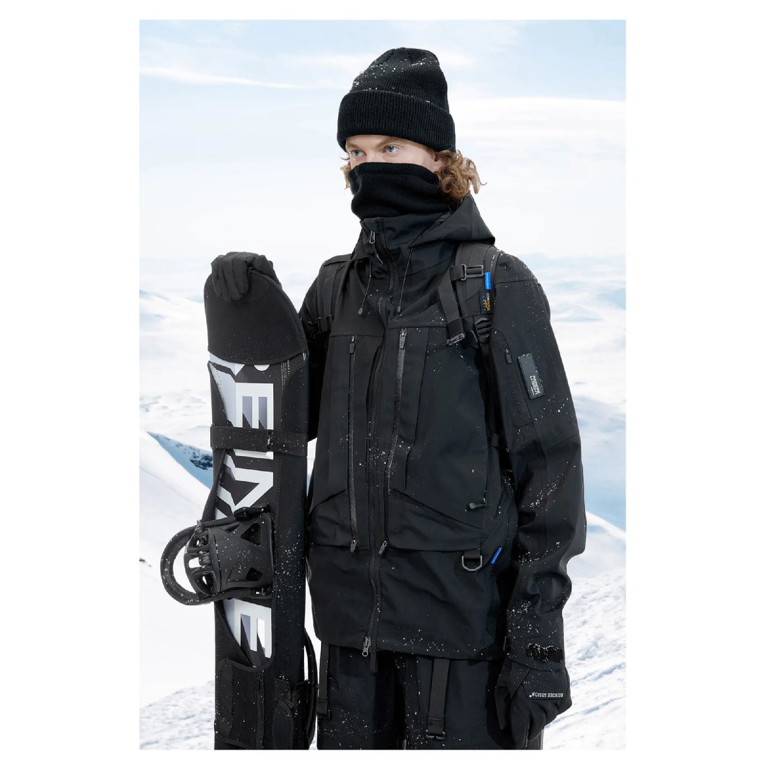A man wearing The 0107 Ski Down Techwear Jacket in Black Color and holding the snow ski  