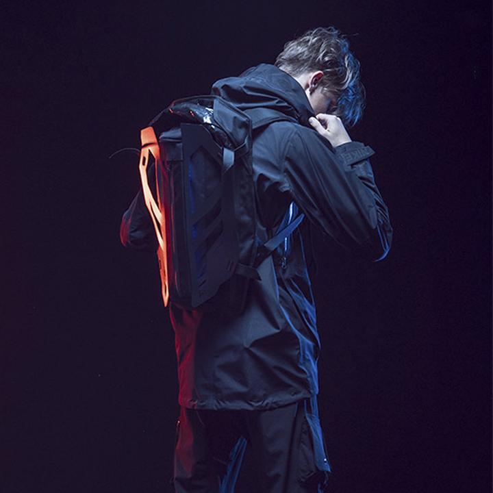 A man wearing the 3D Cyberpunk backpack, techwear jacket, and techwear pants