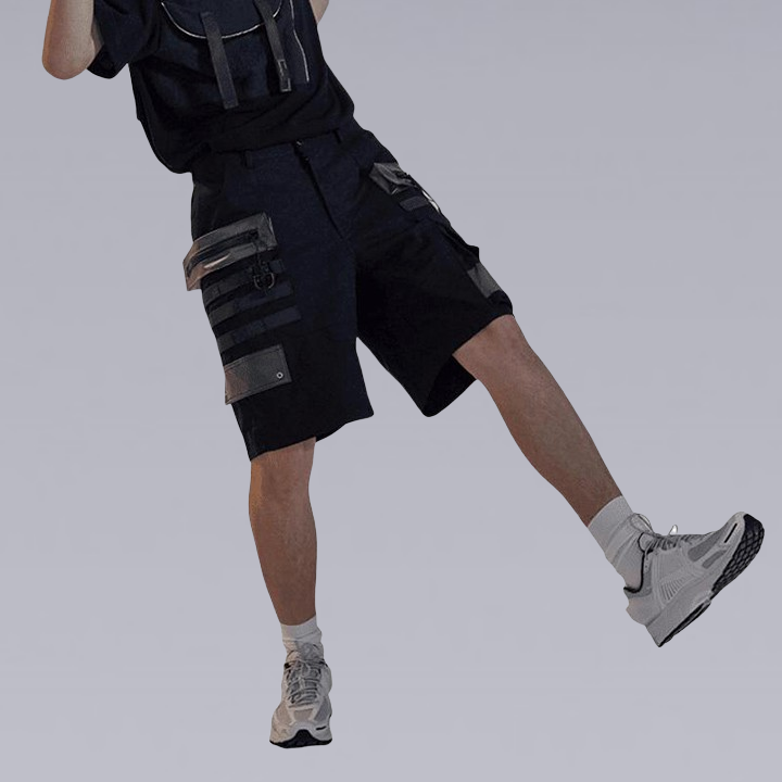 Man standing on one leg wearing the chrrota techwear shorts with multi pockets