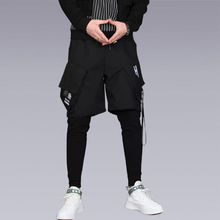 Clotechnow The trouser is designed with an elastic waist and 3/4 length leg and features slanted pockets. Lightweight cotton poplin with functional buttons and functional pockets. FUNCTIONAL STREETWEAR HAREM PANTS.