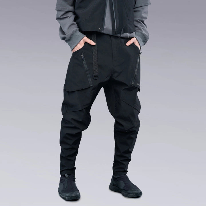 A man is wearing Techwear pants and putting his hands inside his pockets.