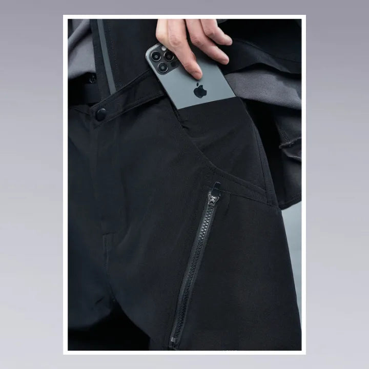 A man is putting his iPhone inside his techwear pants pocket